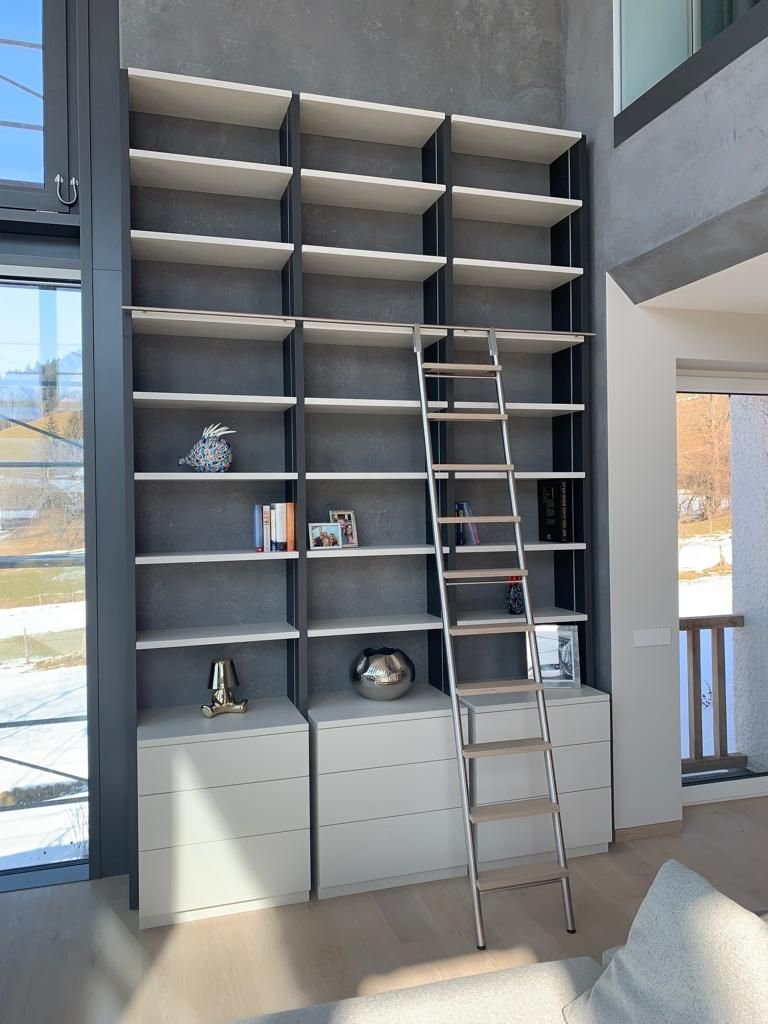 Raumhohes Bücherregal mit Rollleiter in einem hohen Raum